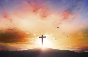 Good Friday concept: Silhouette cross on mountain sunset background
